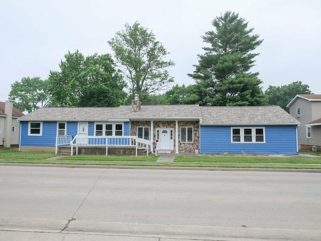 510 W Harrison St, Villa Grove, IL 61956 - single story home featuring covered porch, a chimney, a front lawn, and stone siding