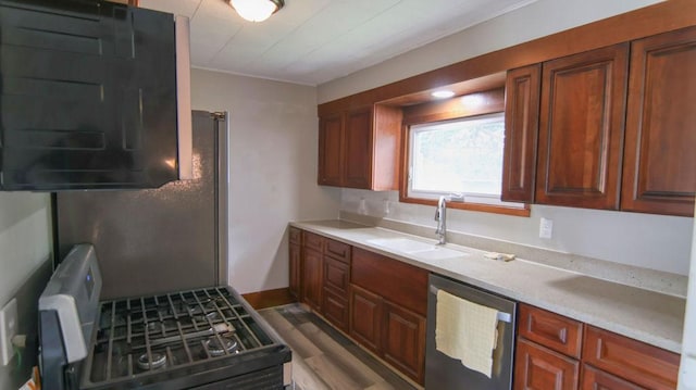510 W Harrison St, Villa Grove, IL 61956 - kitchen with stainless steel dishwasher, a sink, light countertops, and wood finished floors