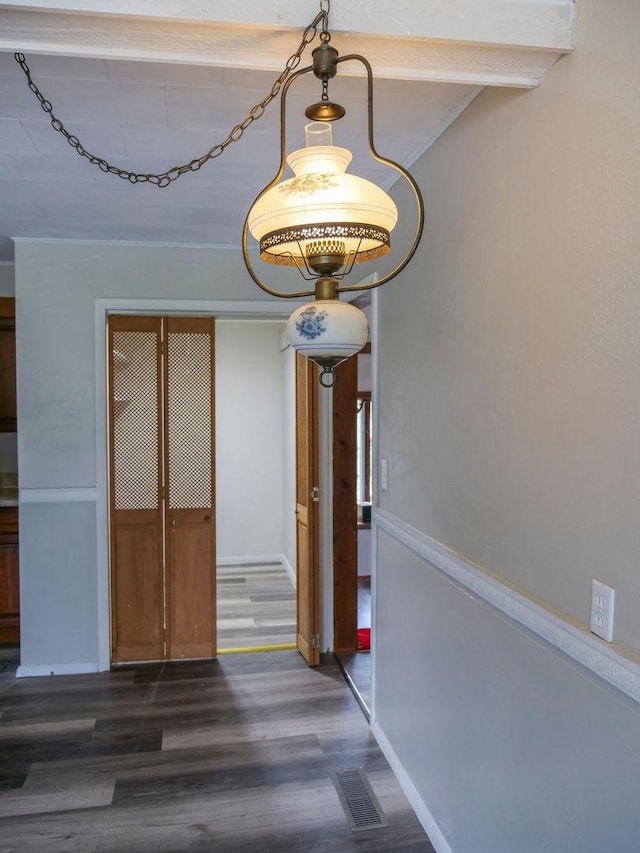 510 W Harrison St, Villa Grove, IL 61956 - unfurnished dining area featuring dark wood-style floors and baseboards