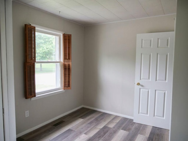 510 W Harrison St, Villa Grove, IL 61956 - empty room featuring wood finished floors, baseboards, and ornamental molding