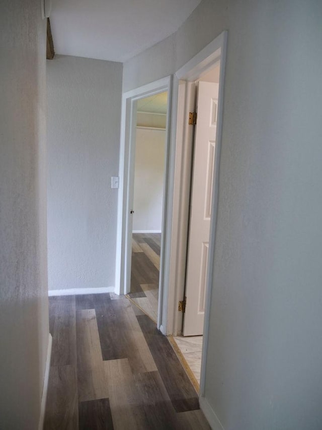 510 W Harrison St, Villa Grove, IL 61956 - hall featuring wood finished floors, a textured wall, and baseboards