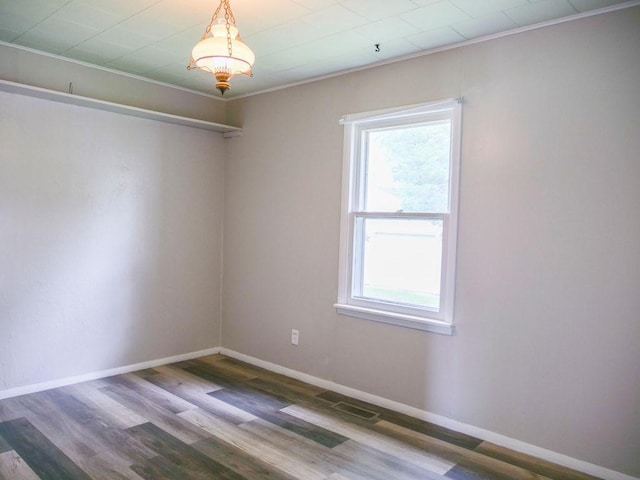 510 W Harrison St, Villa Grove, IL 61956 - spare room featuring healthy amount of natural light, wood finished floors, baseboards, and ornamental molding