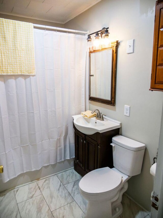 510 W Harrison St, Villa Grove, IL 61956 - bathroom featuring vanity, toilet, marble finish flooring, crown molding, and shower / tub combo with curtain