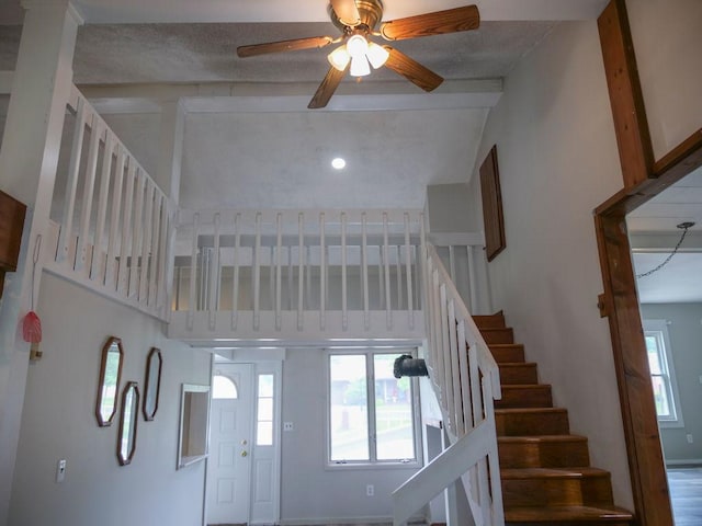 510 W Harrison St, Villa Grove, IL 61956 - staircase featuring ceiling fan, plenty of natural light, a towering ceiling, and beam ceiling