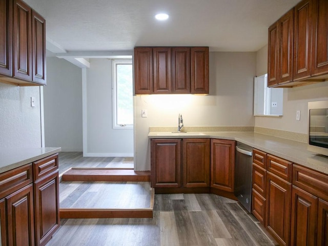 510 W Harrison St, Villa Grove, IL 61956 - kitchen featuring stainless steel dishwasher, a sink, dark wood-style flooring, light countertops, and recessed lighting