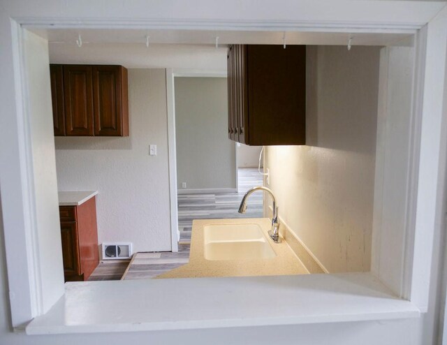 510 W Harrison St, Villa Grove, IL 61956 - kitchen featuring a sink, light countertops, and wood finished floors