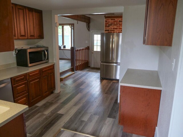 510 W Harrison St, Villa Grove, IL 61956 - kitchen with appliances with stainless steel finishes, light countertops, and dark wood finished floors