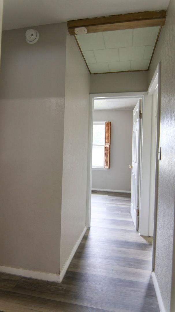 510 W Harrison St, Villa Grove, IL 61956 - hallway featuring wood finished floors and baseboards