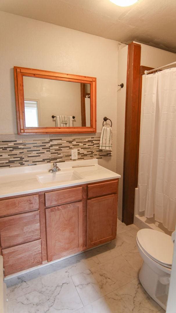 510 W Harrison St, Villa Grove, IL 61956 - full bath featuring toilet, marble finish flooring, and vanity