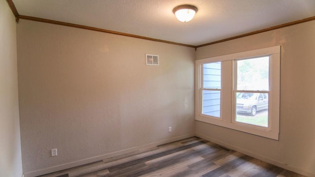 510 W Harrison St, Villa Grove, IL 61956 - empty room with crown molding, wood finished floors, and baseboards