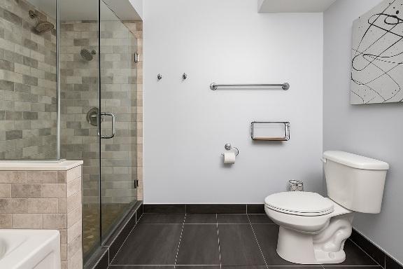 bathroom with tile patterned flooring, a shower stall, a garden tub, toilet, and baseboards