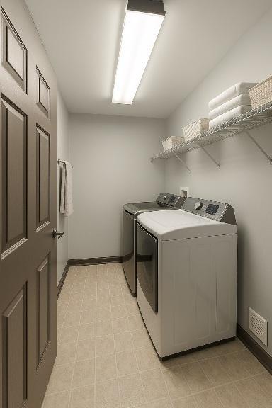 washroom featuring independent washer and dryer and baseboards