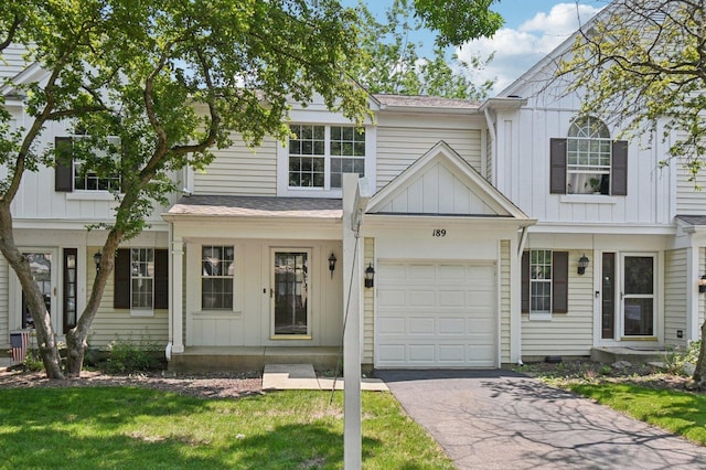 189 Port Royal Cir, Aurora, IL 60504 - view of front facade with driveway, board and batten siding, a front yard, and a garage