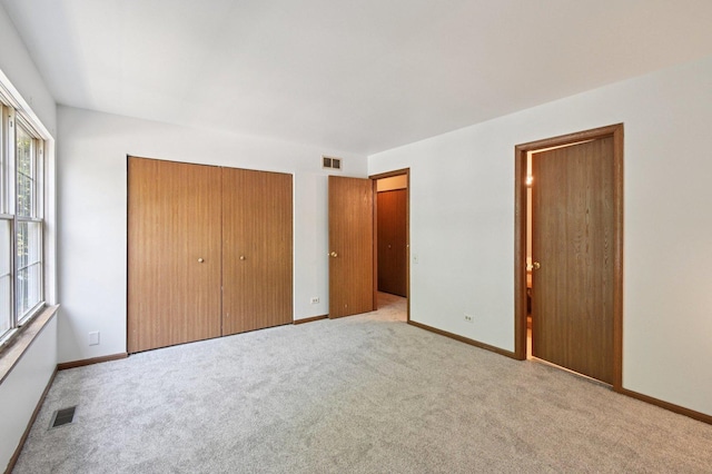 189 Port Royal Cir, Aurora, IL 60504 - unfurnished bedroom featuring a closet and carpet floors