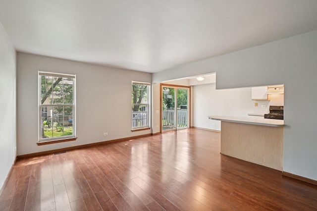 189 Port Royal Cir, Aurora, IL 60504 - unfurnished living room with healthy amount of natural light and dark wood-type flooring