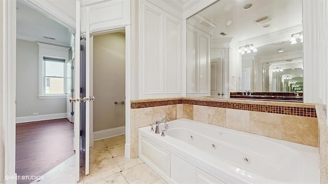 2540 W Diversey Ave Unit 404, Chicago, IL 60647 - bathroom with crown molding, a jetted tub, baseboards, and tile patterned flooring