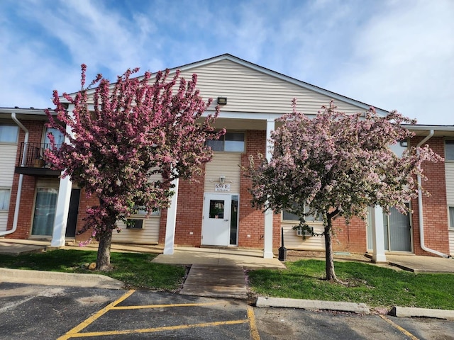 659 E Fullerton Ave Unit 201, Glendale Heights, IL 60139 - view of front of home featuring uncovered parking and brick siding