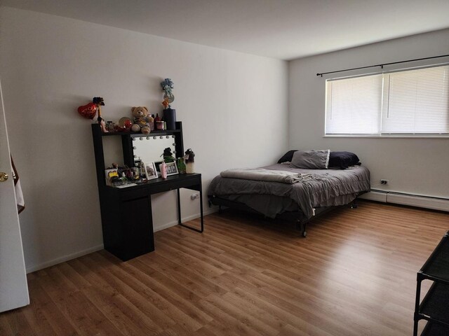 659 E Fullerton Ave Unit 201, Glendale Heights, IL 60139 - bedroom featuring baseboard heating and wood finished floors