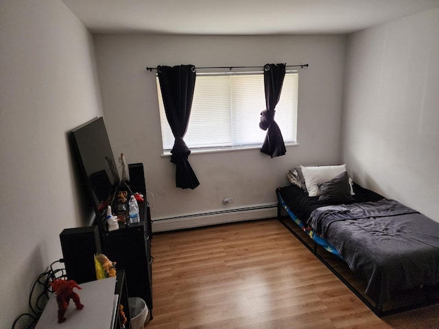 659 E Fullerton Ave Unit 201, Glendale Heights, IL 60139 - bedroom featuring baseboard heating and wood finished floors