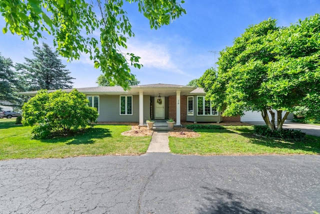 28 Lions Rd, Sandwich, IL 60548 - view of front facade featuring a front lawn and an attached garage