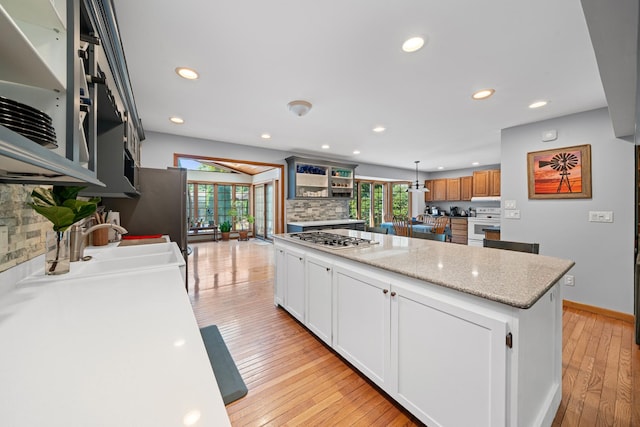 28 Lions Rd, Sandwich, IL 60548 - kitchen with stainless steel gas stovetop, open shelves, healthy amount of natural light, tasteful backsplash, and recessed lighting