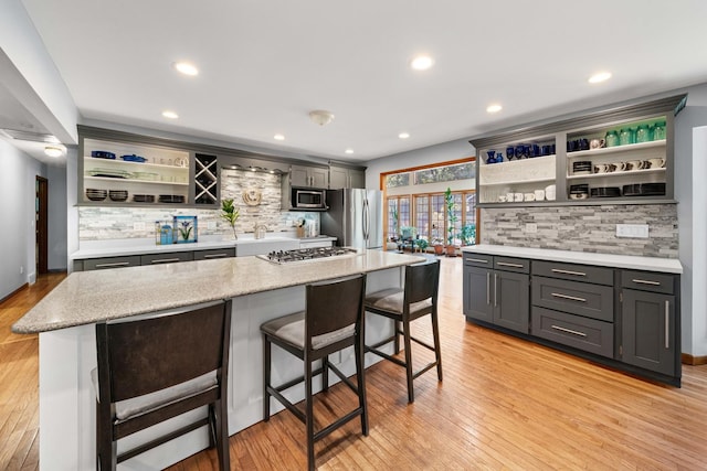 28 Lions Rd, Sandwich, IL 60548 - kitchen with open shelves, stainless steel appliances, tasteful backsplash, light wood-style floors, and recessed lighting