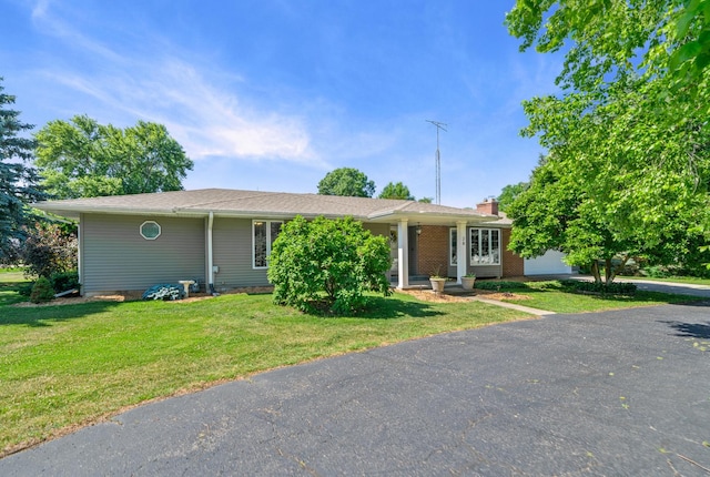 28 Lions Rd, Sandwich, IL 60548 - single story home featuring a front lawn and a chimney