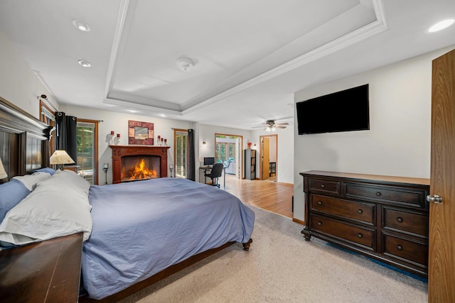 28 Lions Rd, Sandwich, IL 60548 - bedroom featuring a raised ceiling, a warm lit fireplace, recessed lighting, and light carpet