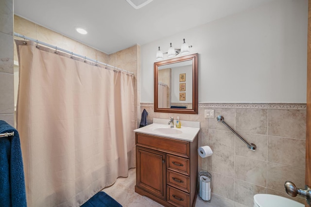 28 Lions Rd, Sandwich, IL 60548 - bathroom featuring tile walls, vanity, a shower with shower curtain, and a wainscoted wall