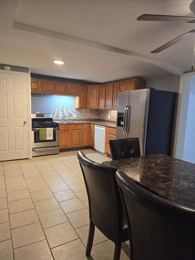 1003 S Pleasantview Dr, Tuscola, IL 61953 - kitchen featuring stainless steel appliances, a ceiling fan, brown cabinets, recessed lighting, and a sink