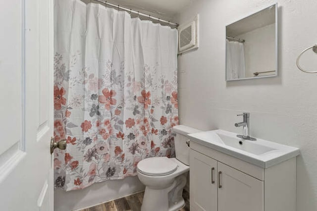 1003 S Pleasantview Dr, Tuscola, IL 61953 - bathroom with wood finished floors, vanity, and toilet
