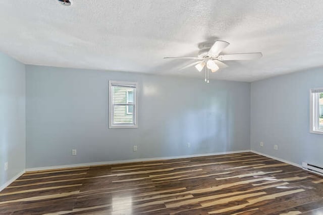 1003 S Pleasantview Dr, Tuscola, IL 61953 - spare room featuring ceiling fan, wood finished floors, a textured ceiling, and baseboards
