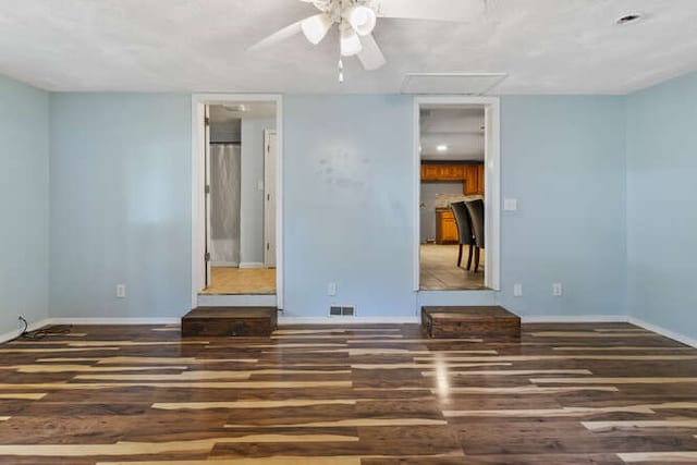 1003 S Pleasantview Dr, Tuscola, IL 61953 - empty room featuring wood finished floors, ceiling fan, and baseboards