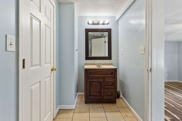1003 S Pleasantview Dr, Tuscola, IL 61953 - bathroom featuring vanity, baseboards, and tile patterned floors