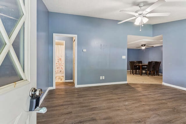 1003 S Pleasantview Dr, Tuscola, IL 61953 - empty room featuring a ceiling fan, wood finished floors, and baseboards