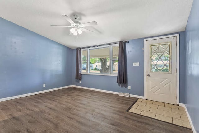 1003 S Pleasantview Dr, Tuscola, IL 61953 - foyer entrance with wood finished floors, ceiling fan, baseboards, and vaulted ceiling