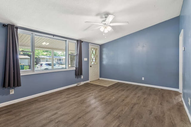 1003 S Pleasantview Dr, Tuscola, IL 61953 - spare room featuring ceiling fan, wood finished floors, baseboards, and vaulted ceiling