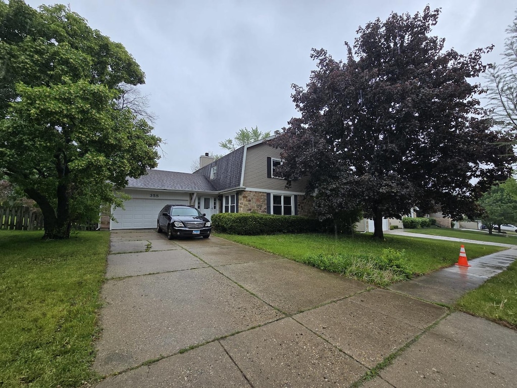 355 Crestwood Ct, Algonquin, IL 60102 - colonial inspired home with a front lawn, an attached garage, concrete driveway, a chimney, and stone siding