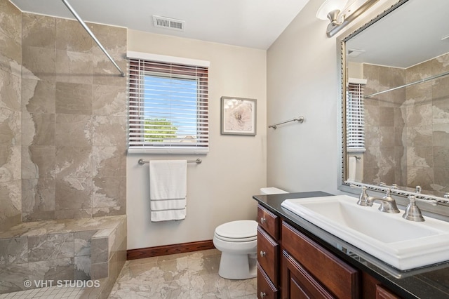 9008 Marmora Ave, Morton Grove, IL 60053 - bathroom with vanity, a tile shower, and marble finish floors