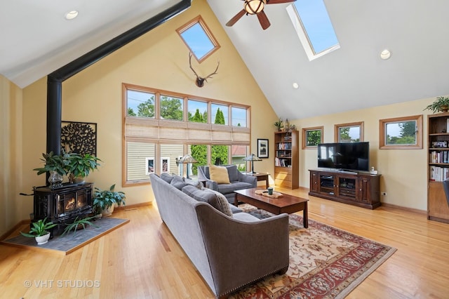 9008 Marmora Ave, Morton Grove, IL 60053 - living room with a wood stove, high vaulted ceiling, ceiling fan, light wood finished floors, and plenty of natural light