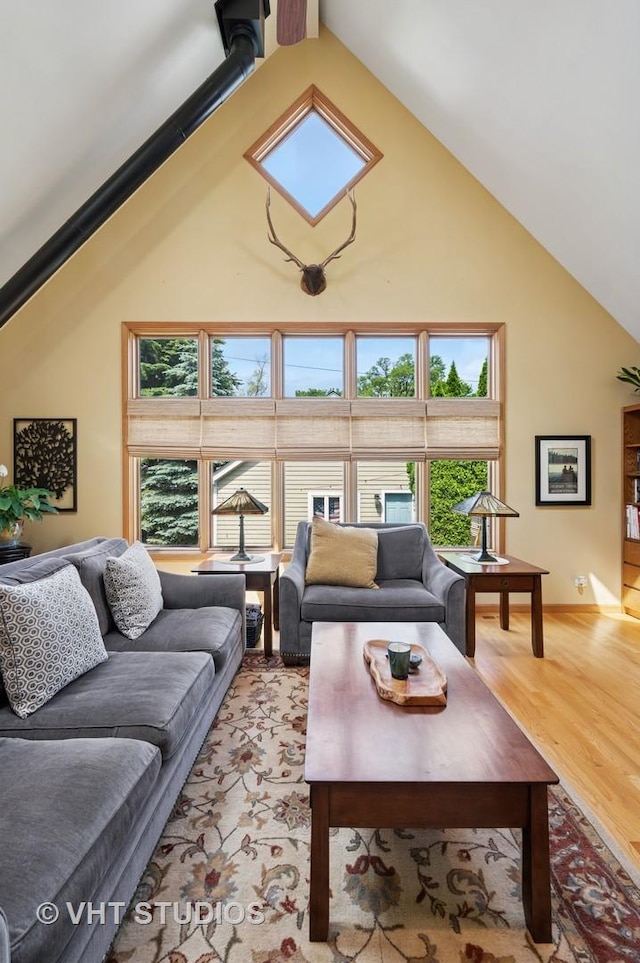 9008 Marmora Ave, Morton Grove, IL 60053 - living room with high vaulted ceiling and light wood-style flooring