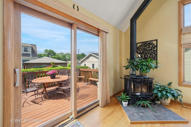 9008 Marmora Ave, Morton Grove, IL 60053 - entryway featuring a wood stove, lofted ceiling, and wood finished floors