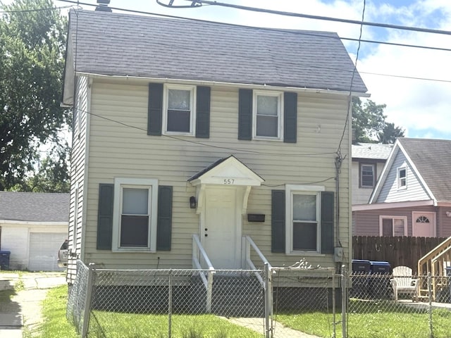557 W Water St, Waukegan, IL 60085 - view of front facade featuring a fenced front yard and roof with shingles