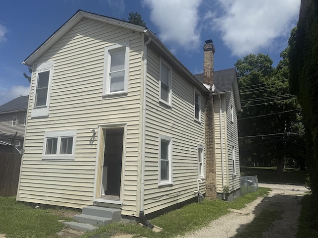 557 W Water St, Waukegan, IL 60085 - back of property with a chimney and entry steps