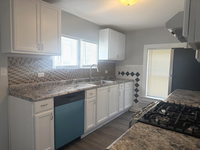 557 W Water St, Waukegan, IL 60085 - kitchen featuring dishwasher, freestanding refrigerator, white cabinetry, tile walls, and wainscoting