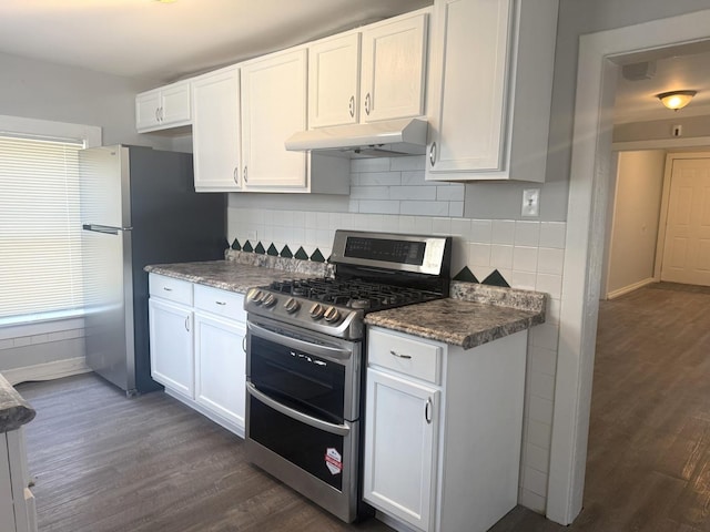 557 W Water St, Waukegan, IL 60085 - kitchen with stainless steel appliances, under cabinet range hood, dark wood-type flooring, white cabinets, and backsplash