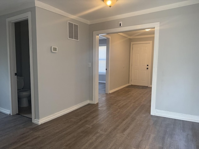 557 W Water St, Waukegan, IL 60085 - empty room featuring dark wood finished floors and crown molding