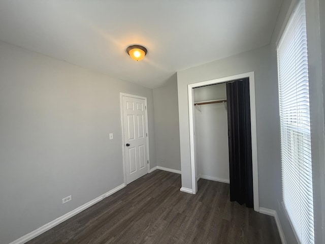 557 W Water St, Waukegan, IL 60085 - unfurnished bedroom featuring dark wood-style floors and a closet
