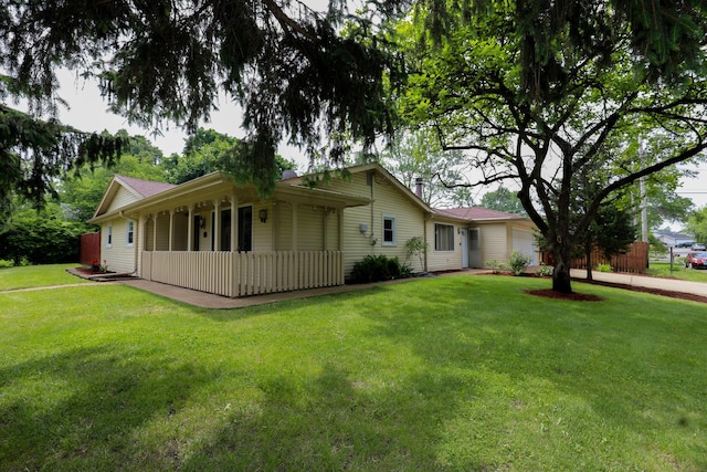 19421 W Hoag Ct, Mundelein, IL 60060 - view of side of home with an attached garage, a yard, and a porch