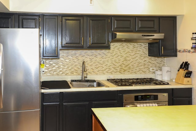 19421 W Hoag Ct, Mundelein, IL 60060 - kitchen featuring stainless steel appliances, under cabinet range hood, a sink, light countertops, and tasteful backsplash
